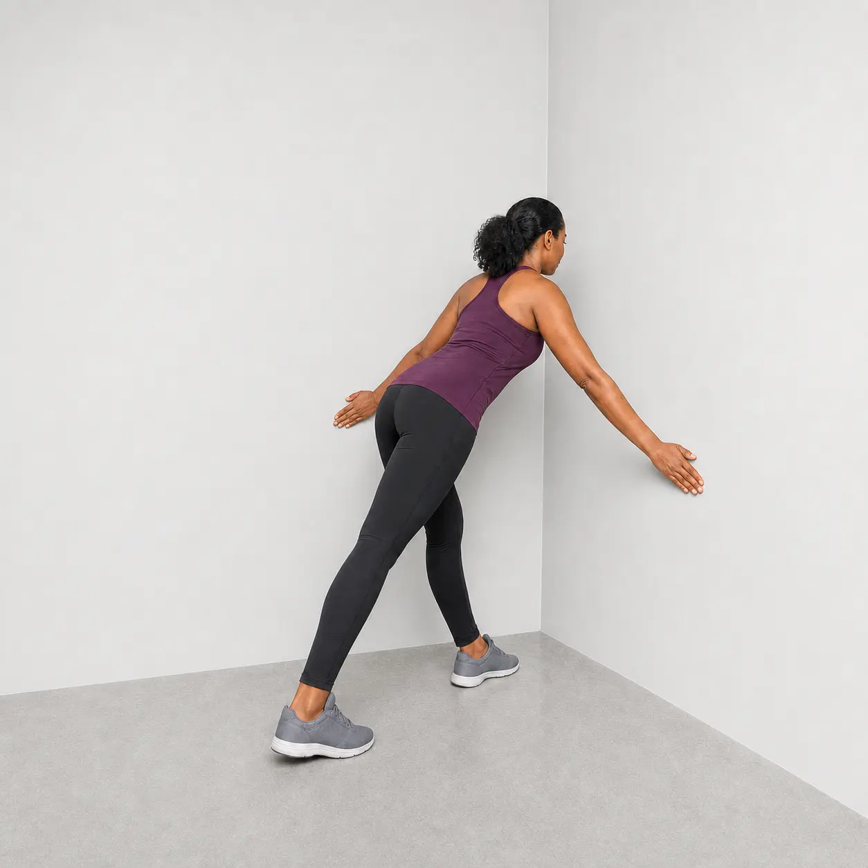 Corner stretch with hands low on the walls
