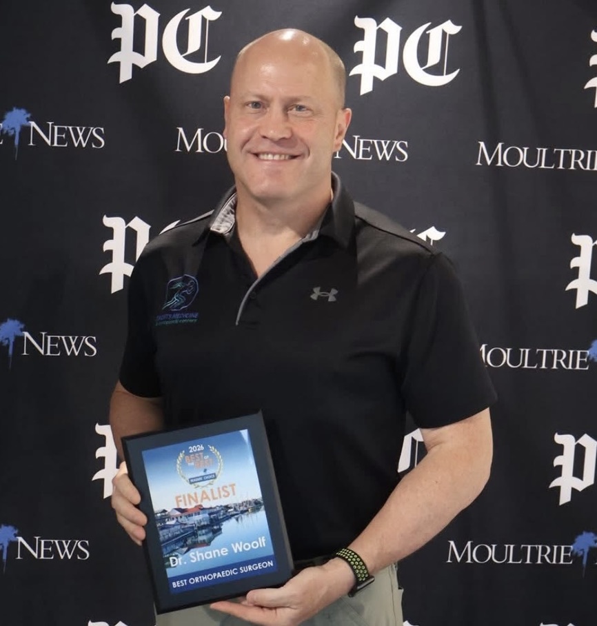 Dr. Shane Woolf holding the 2026 Best Orthopaedic Surgeon finalist award in Mount Pleasant, SC