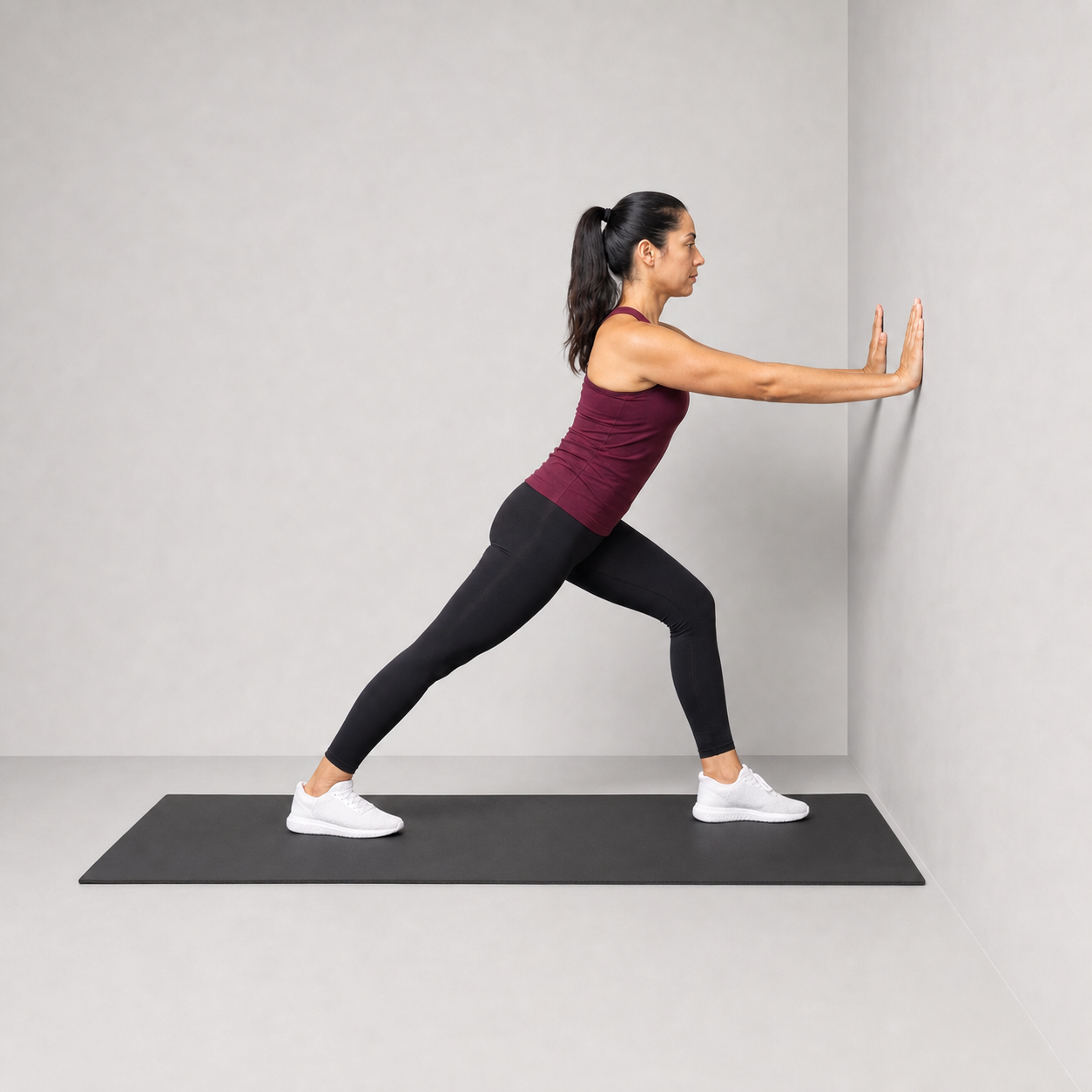 Standing calf stretch against a wall